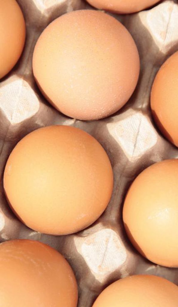 close up shot of brown eggs in a carton