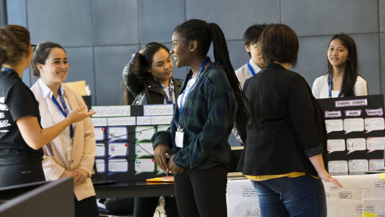 High school girls presenting ideas at a science fair