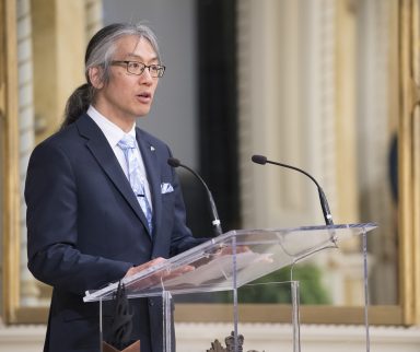 Man standing at podium accepting an award