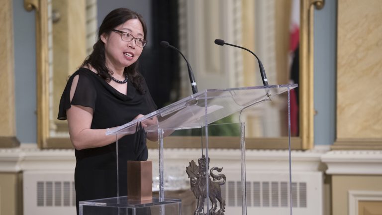 Woman standing at podium receiving award