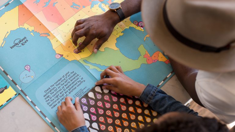 An adult teaching a child how to read a map