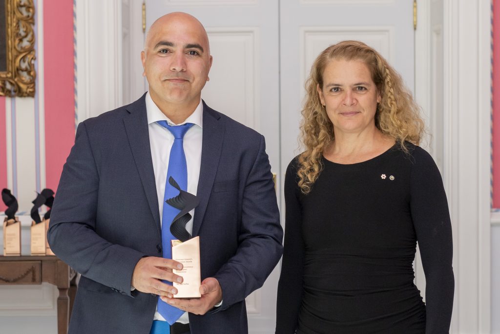 A man receiving his GGIA award