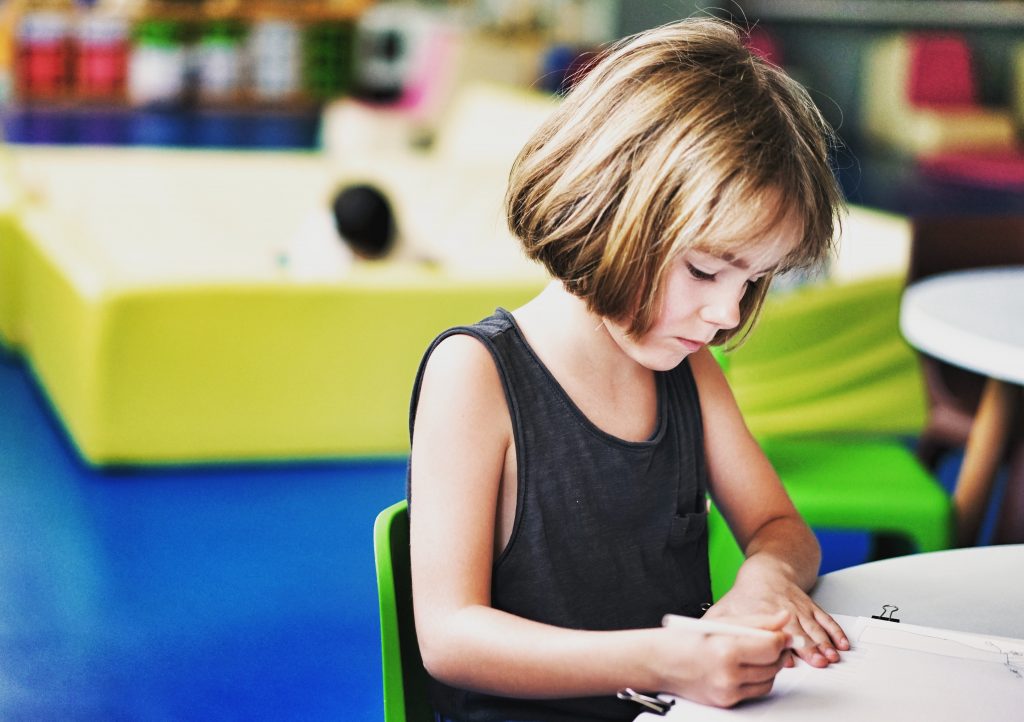 A child writing onto a paper