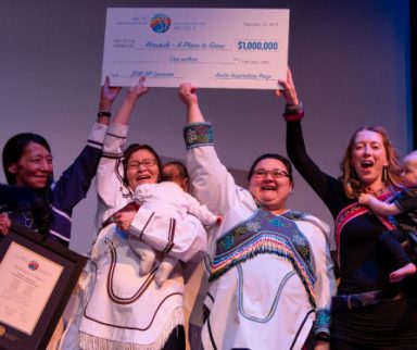 A group of people holding a large cheque