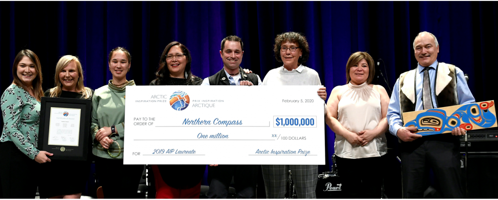 Northern compass holding a one million dollar cheque