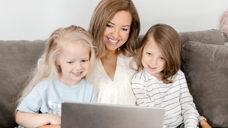mother and two girls on laptop
