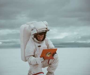 astronaut holding a book