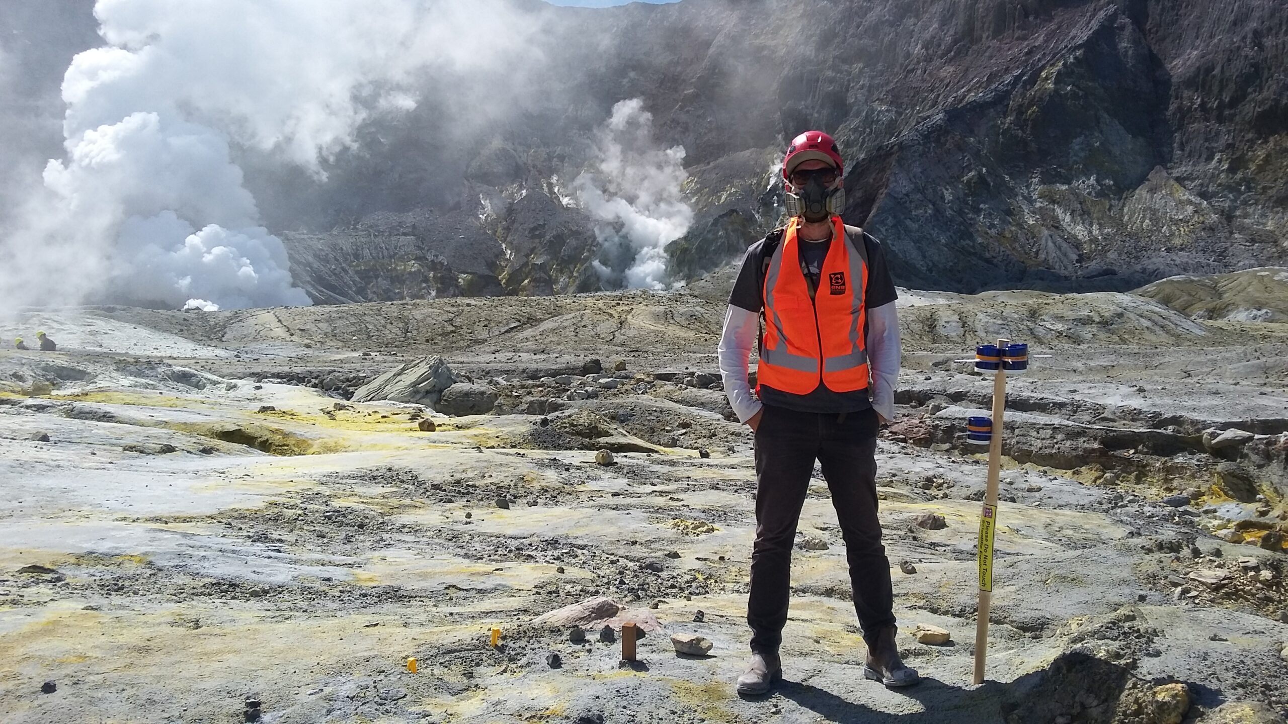 man at volcano site with protective gear
