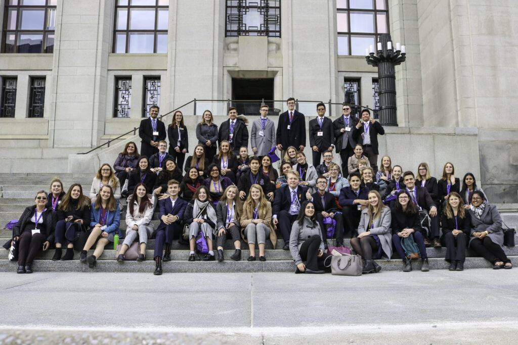 youth sitting on steps at forum conference