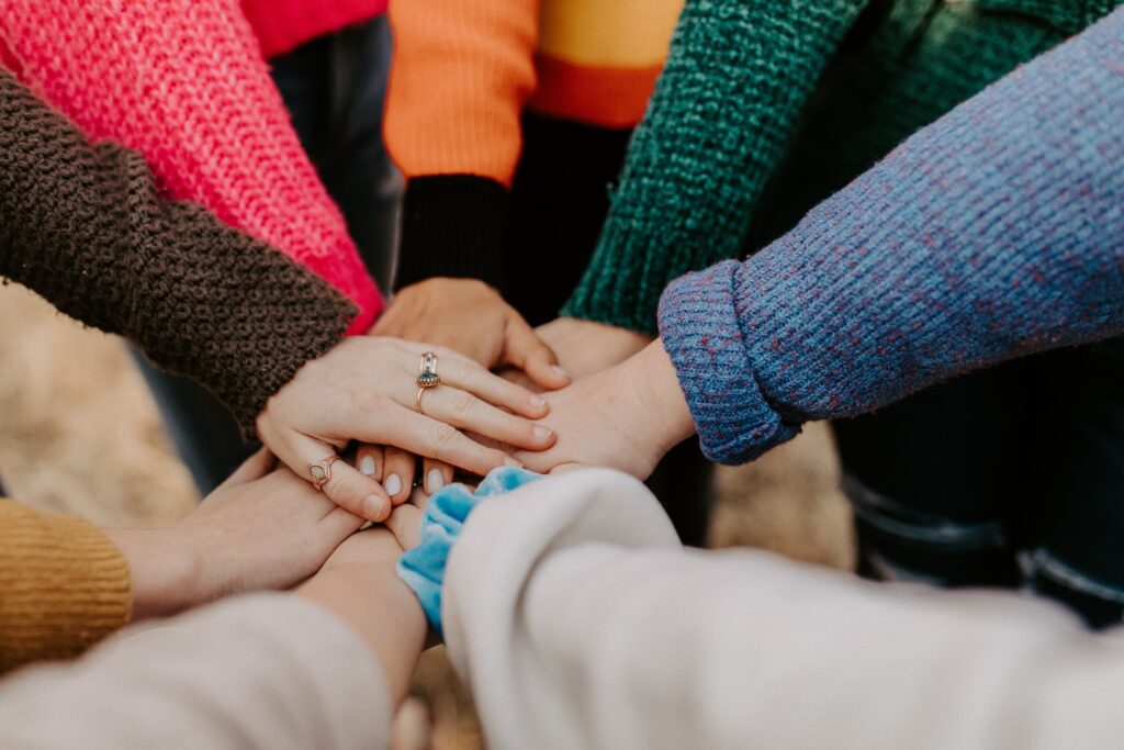 A group of people with their hands joined together